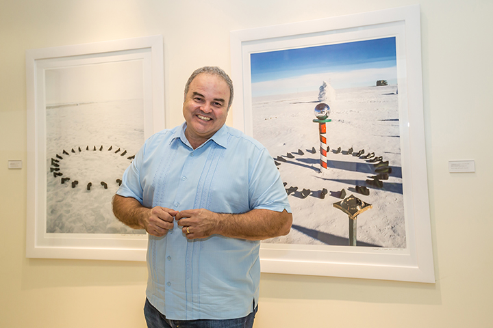 UM alumnus and artist Xavier Cortada poses in front of his artwork, Longitudinal Installation. UM alumnus and artist Xavier Cortada
